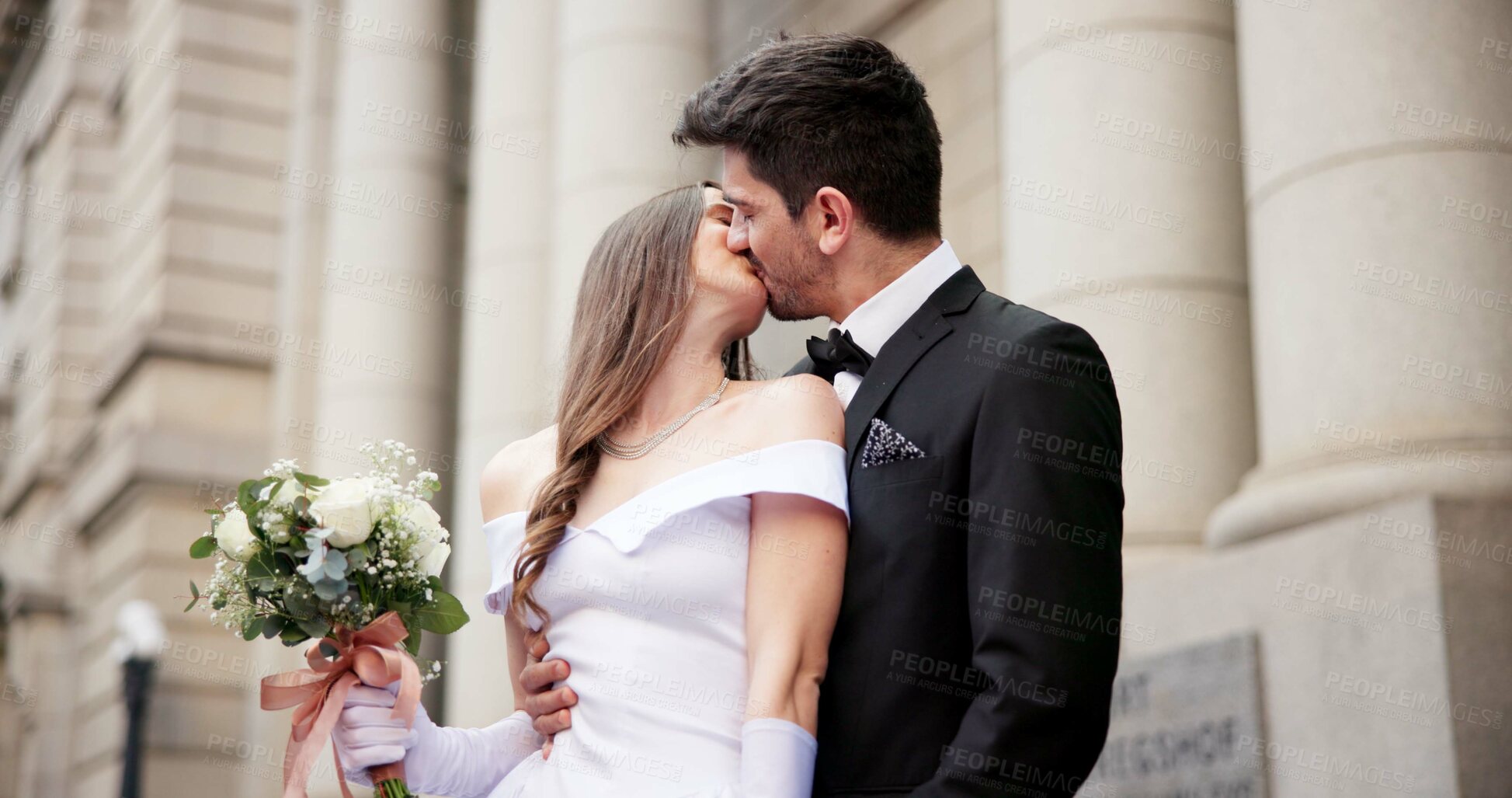 Buy stock photo Wedding, kiss and couple in city for love at marriage ceremony, celebration and event. Romance, affection and man and woman embrace for commitment, partnership and promise for court certificate