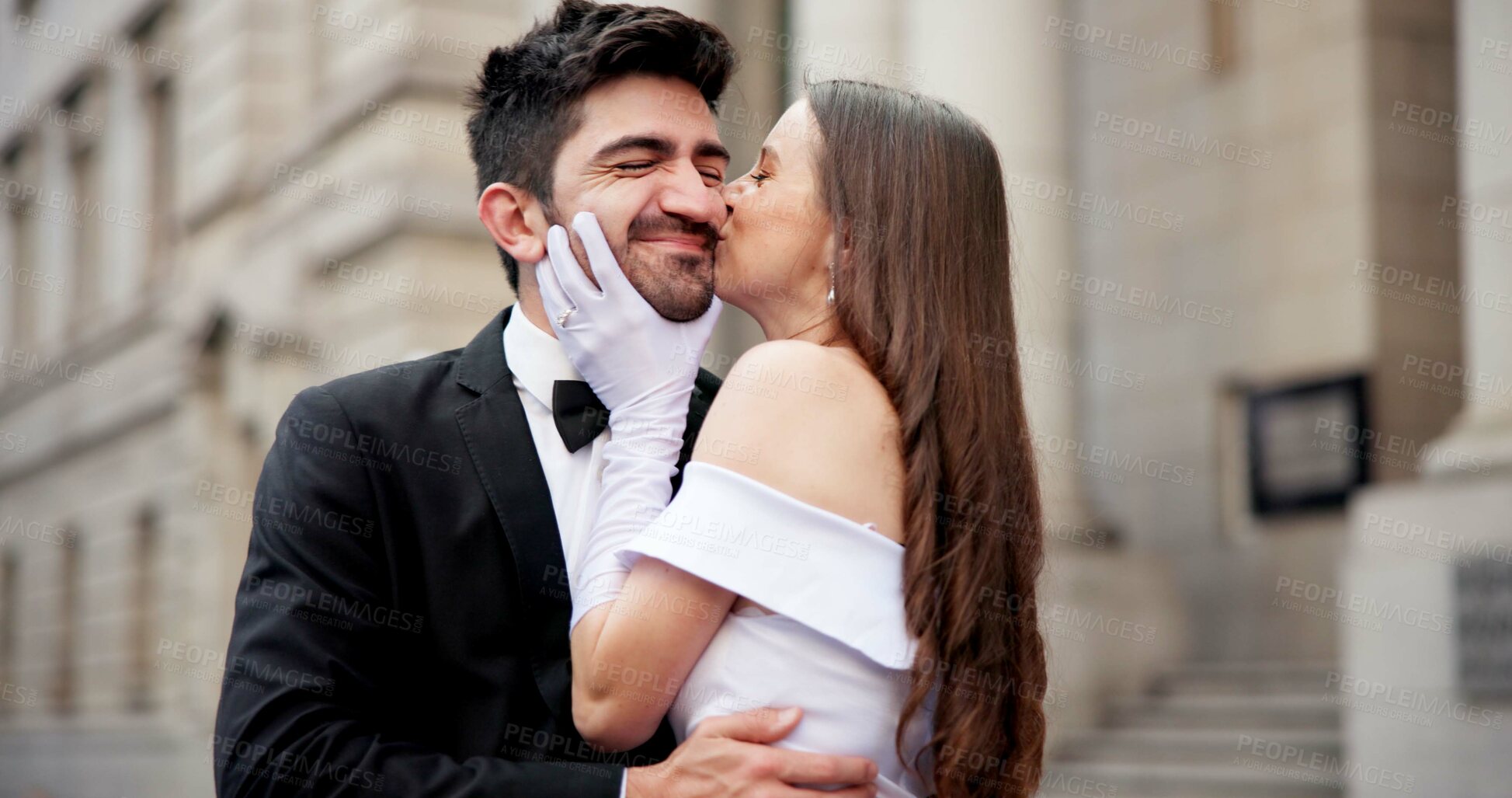 Buy stock photo City, building and couple at wedding with kiss, love and excited bride with groom in street together. Urban romance, man and woman with fun court marriage, commitment and happy outdoor celebration.