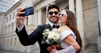Buy stock photo Wedding, city and selfie with smile at courthouse with bride, love and bouquet for celebration with sunglasses. Social media, profile picture and marriage event for commitment, loyalty and trust