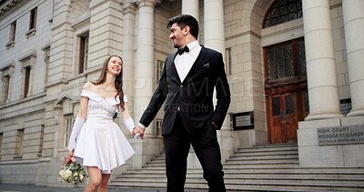 Buy stock photo Wedding, holding hands and couple in city for love at marriage ceremony, celebration and union at court. Romance, bride and groom and man and woman in town for commitment, partnership and promise