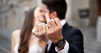 Hands, rings and couple kiss on wedding with promise, celebration and marriage commitment at court. People, bride and groom with jewellery of partnership, relationship trust and ceremony announcement