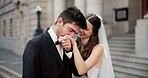 Happy, couple and kiss on hand for wedding with promise, celebration and marriage commitment. Smile, people and love with affection for partnership, relationship loyalty and romance ceremony at court