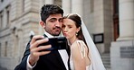 Couple, selfie and celebration with wedding in city, love or happy for commitment, memory and post on web. People, man and woman for marriage, event or funny face with smile on social media in Greece