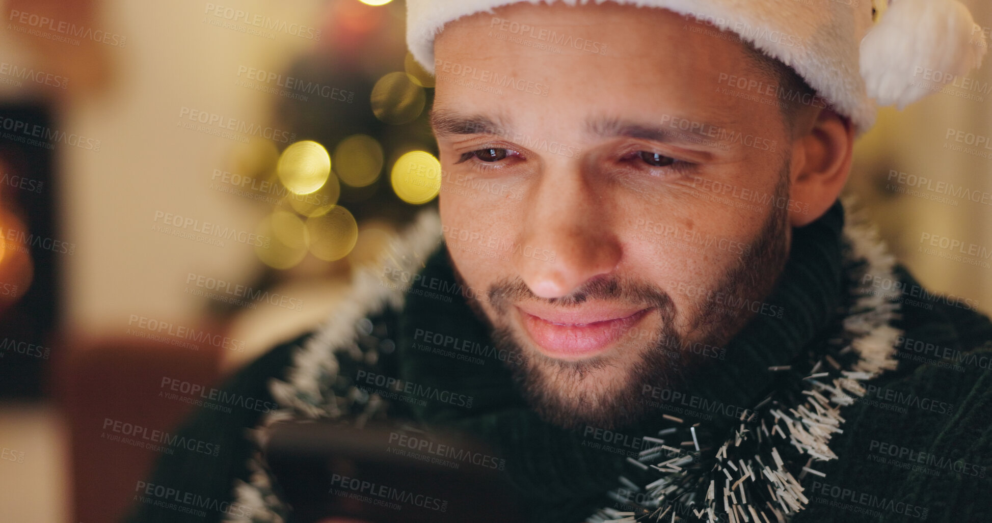 Buy stock photo Christmas, happy and man with phone in home for holiday, vacation and festive season. Relax, night and person on smartphone for reading xmas message on social media, internet chat and mobile app