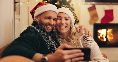 Buy stock photo Christmas, happy and selfie of couple in home take photo for profile picture, social media post and memory. Love, bonding and man and woman hug on sofa for festive tradition, holiday and vacation