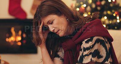 Buy stock photo Woman, sad and thinking on sofa by Christmas tree, trauma or bad memory with headache in home. Mature person, depression and lonely with mental health on couch at xmas with reflection in house