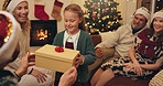 Christmas, family and child with gift in home for festive tradition, holiday and celebration together. Happy, excited and grandparents, parents and girl with box, present and surprise for bonding
