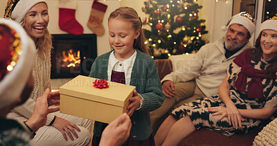 Buy stock photo Christmas, family and child with gift in home for festive tradition, holiday and celebration together. Happy, excited and grandparents, parents and girl with box, present and surprise for bonding