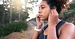 Girl, runner and earphones in road, nature and perspective with music, break or training for fitness in summer. Woman, reflection and streaming for exercise, workout and path by forest in Costa Rica