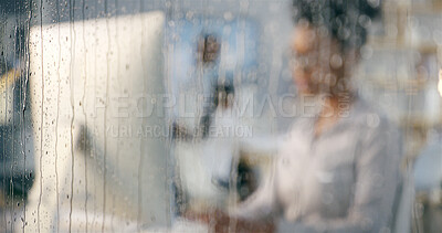 Buy stock photo Rain, office and window with work of woman at computer for digital update of website at job. Blur, drops and glass with professional web design employee at social media and creative agency in winter