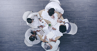 Buy stock photo Top view, business people and team meeting, discussion or planning on tablet with paper in creative startup. Group, above and brainstorming ideas in collaboration for project, logo design or strategy