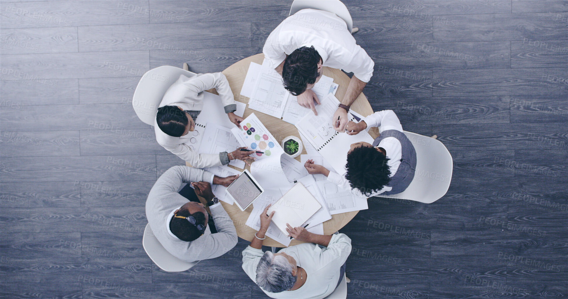 Buy stock photo Top view, business people and team meeting, discussion or planning on tablet with paper in creative startup. Group, above and brainstorming ideas in collaboration for project, logo design or strategy