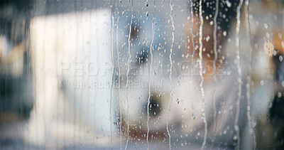 Buy stock photo Rain, office and window closeup with work of woman at computer for digital update of website at job. Blur, drops and glass with professional web design employee at social media and creative agency