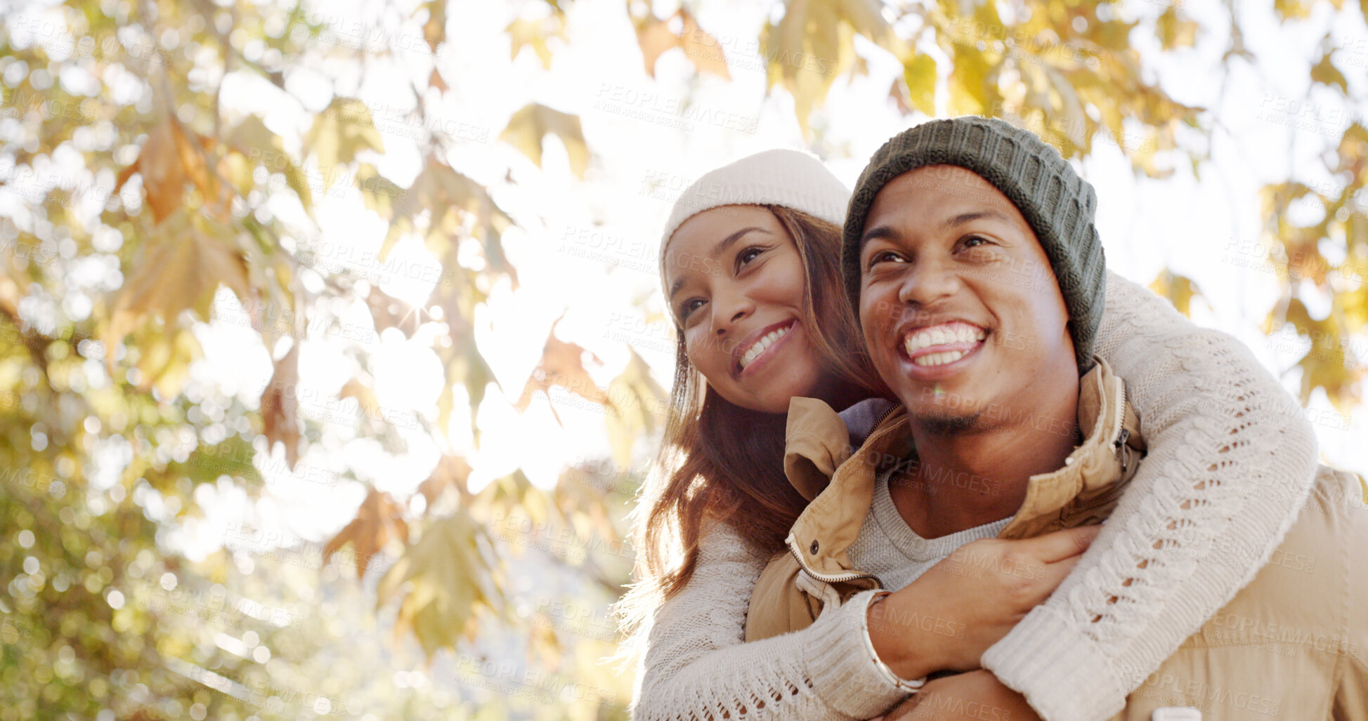 Buy stock photo Park, couple and smile on piggyback for bonding, love and support as lovers for trust. People, outdoor and happy on relationship in autumn for romance, care and affection together on valentines day