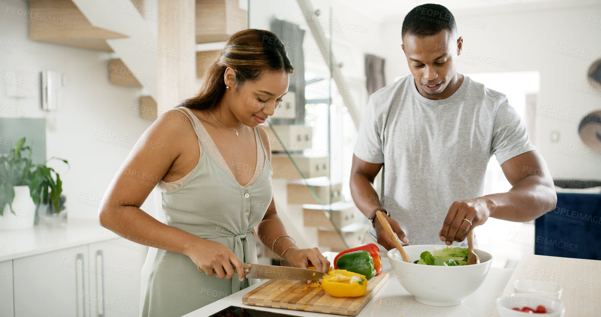 Buy stock photo Couple, kitchen and smile with cutting vegetables for salad at home for meal prep, lunch and nutrition. Apartment, people and happy in relationship with food on bowl for support, love and bonding