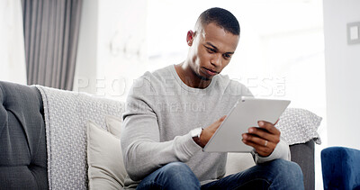 Buy stock photo Man, tablet and relax on sofa with ebook, streaming service and ecommerce in home. Male person, scroll and tech in living room for social media app, online shopping or connectivity for game download