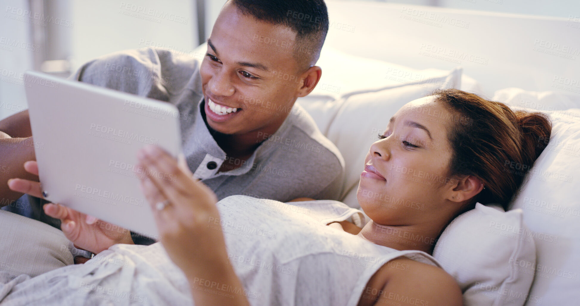 Buy stock photo Tablet, relax and happy couple on bed in home choosing movie, film or show for streaming online together. Love, rest and young man and woman with technology for browsing social media in bedroom.