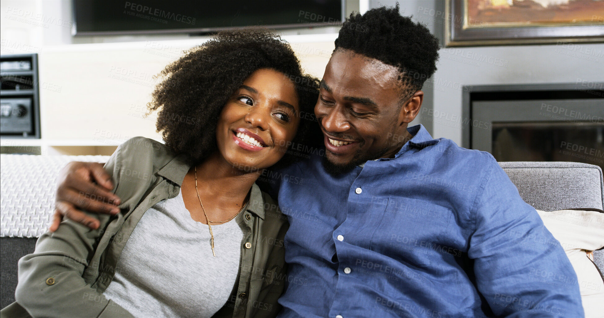 Buy stock photo Happy, hugging and black couple on sofa in home for connection, bonding and date in lounge. Smile, talk and African man and woman relax in conversation for relationship communication in house.