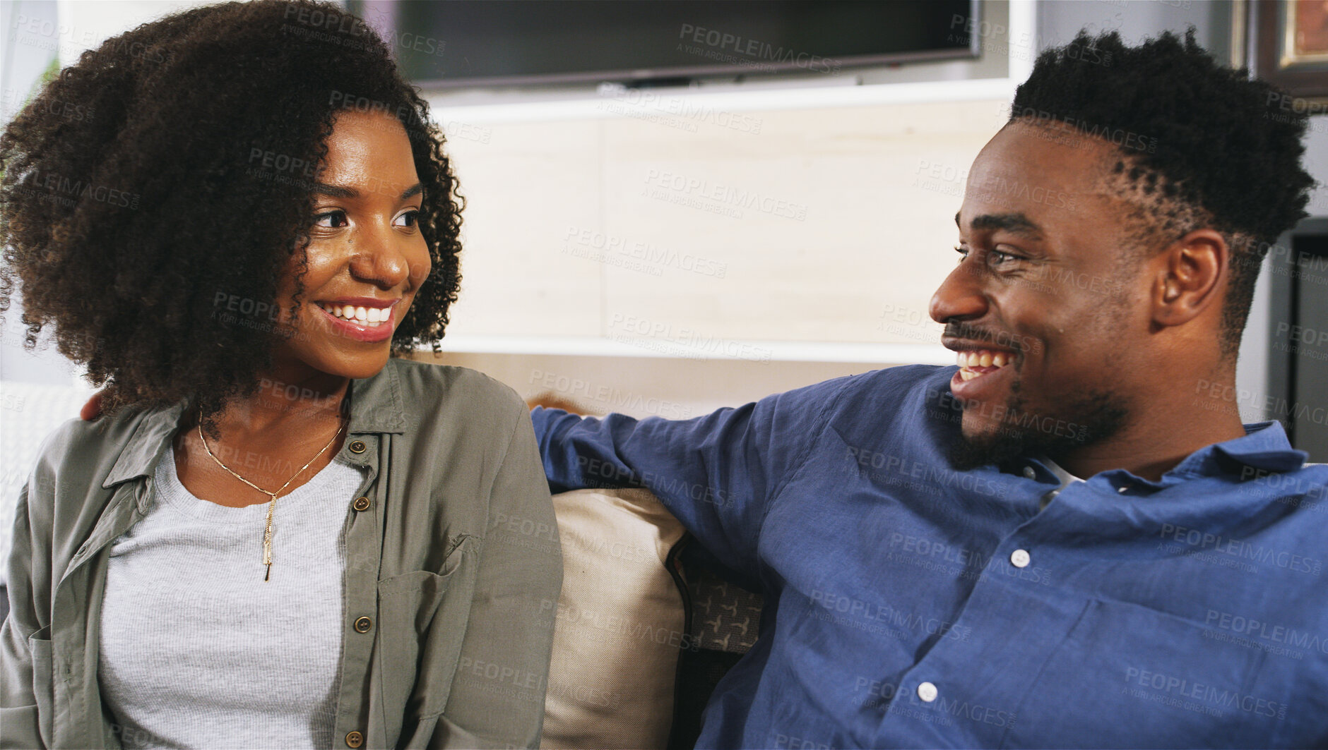 Buy stock photo Happy, conversation and black couple on sofa in home for connection, bonding and date in lounge. Smile, talk and African man and woman relax in conversation for relationship communication in house.