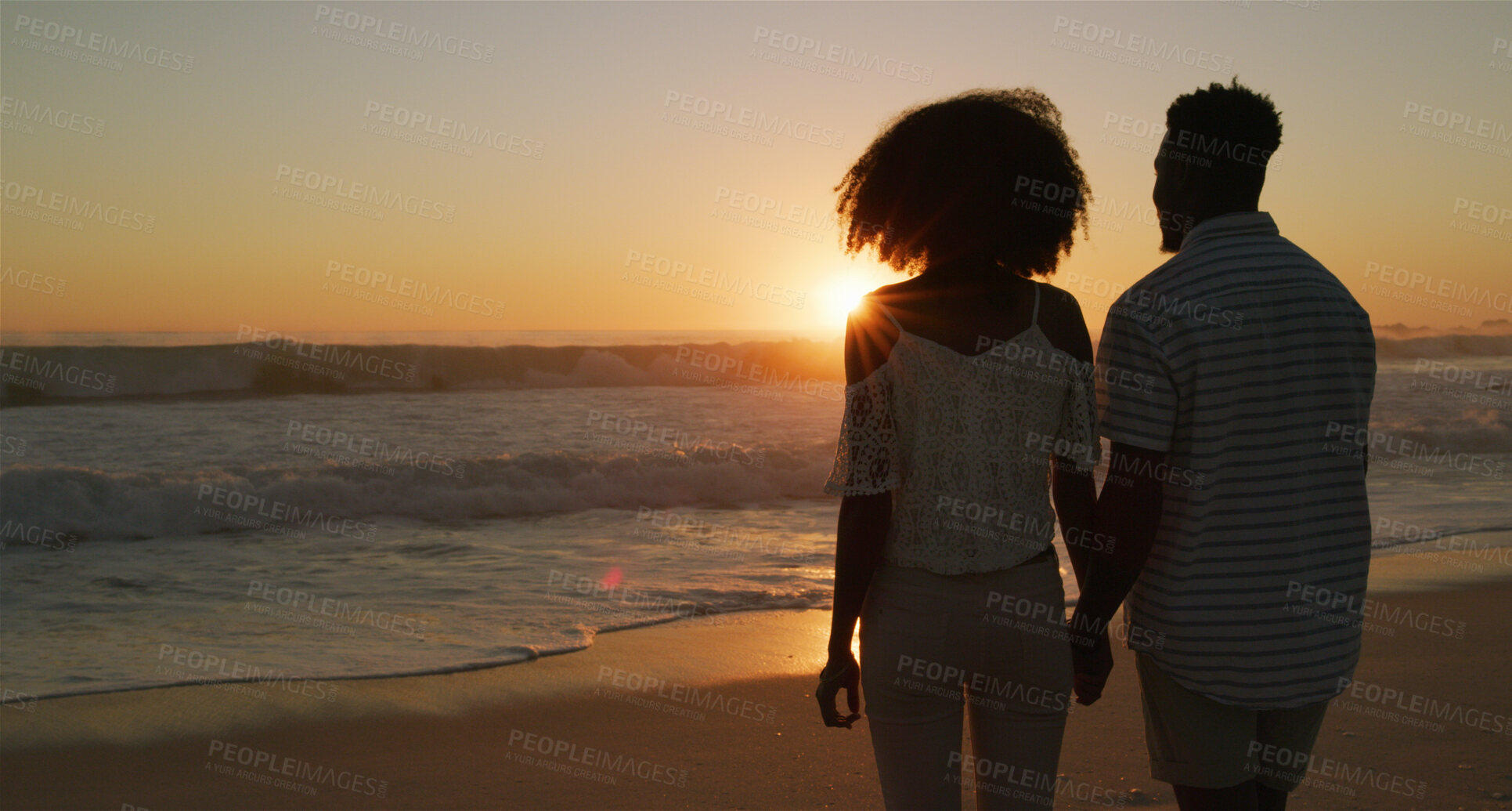 Buy stock photo Couple, sunset and holding hands at beach for love, holiday and travel together with back, care or trust. Man, woman and bonding by ocean for vacation, romance or connection with relationship on date