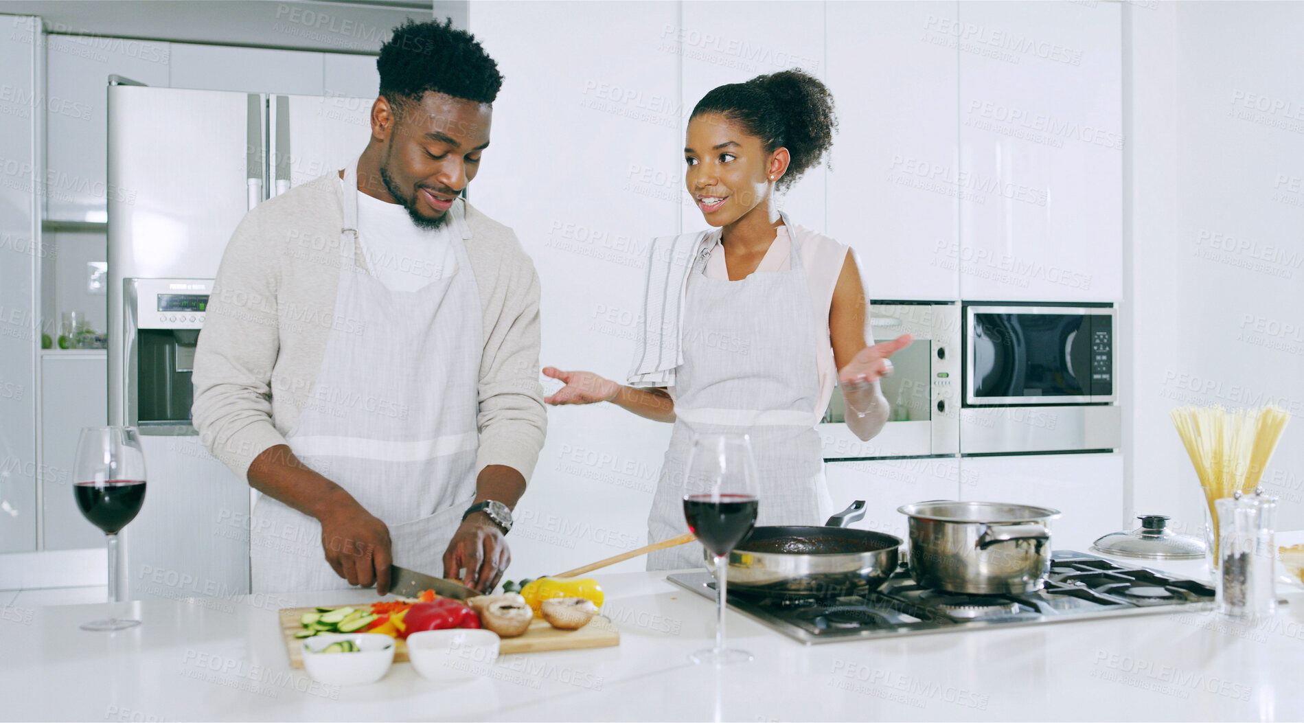 Buy stock photo Couple, kitchen and cooking with wine glasses on conversation, bonding and love. Home, people and relationship with food or vegetables for meal prep, romantic dinner and nutrition for valentines day 