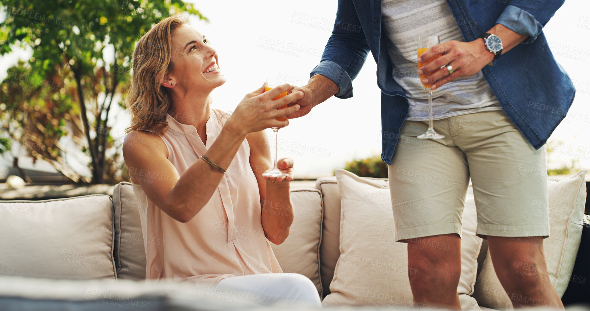 Buy stock photo Happy woman, man and drinks on sofa for vacation, holiday and travel for honeymoon in hotel. Newlyweds, love and mimosa in luxury accommodation for bonding, relationship development or care at resort