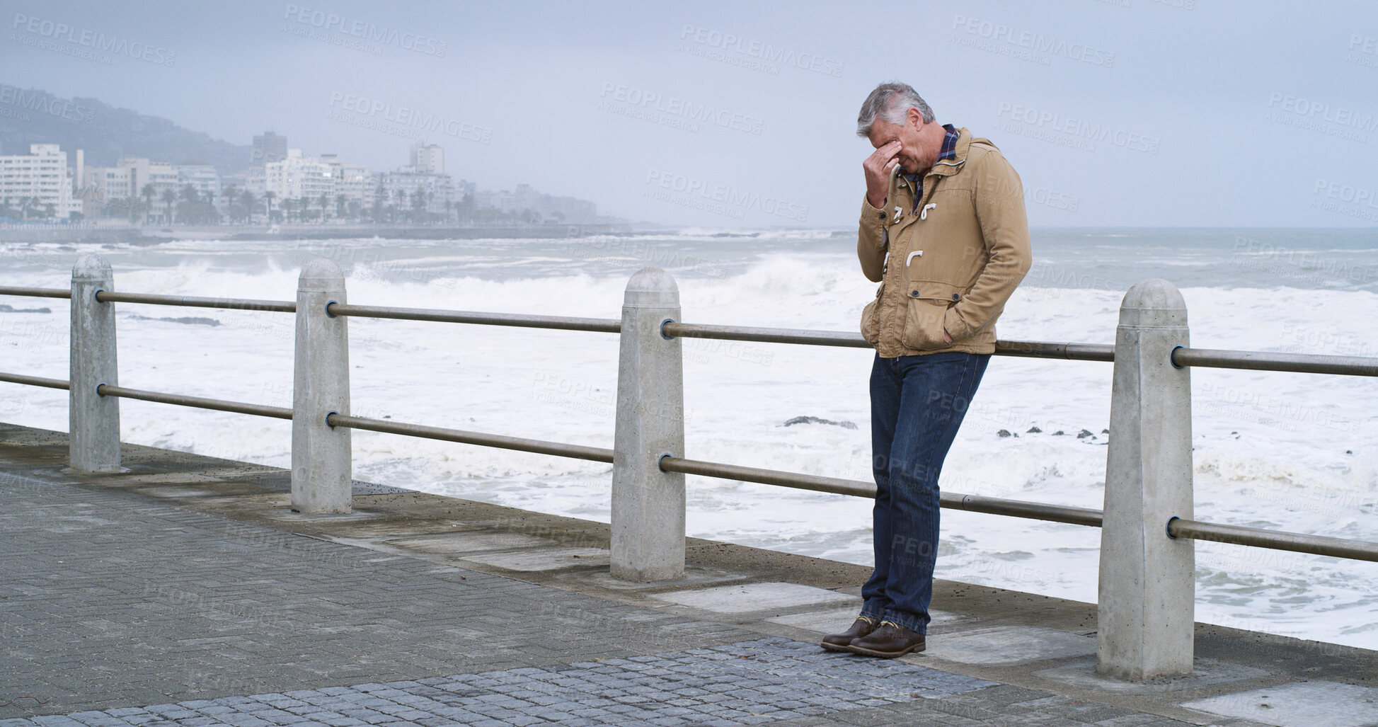 Buy stock photo Senior man, thinking and sad by ocean promenade with headache, stress and reflection. Person, depression and insight for mistake, fog and decision with anxiety by sea, waves and outdoor in Italy