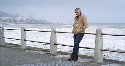 Buy stock photo Mature man, thinking and outdoor by ocean with relax, planning and reflection for break on weekend. Male person, mental health and wellness by seaside, beach or water for ideas, memory or mindfulness
