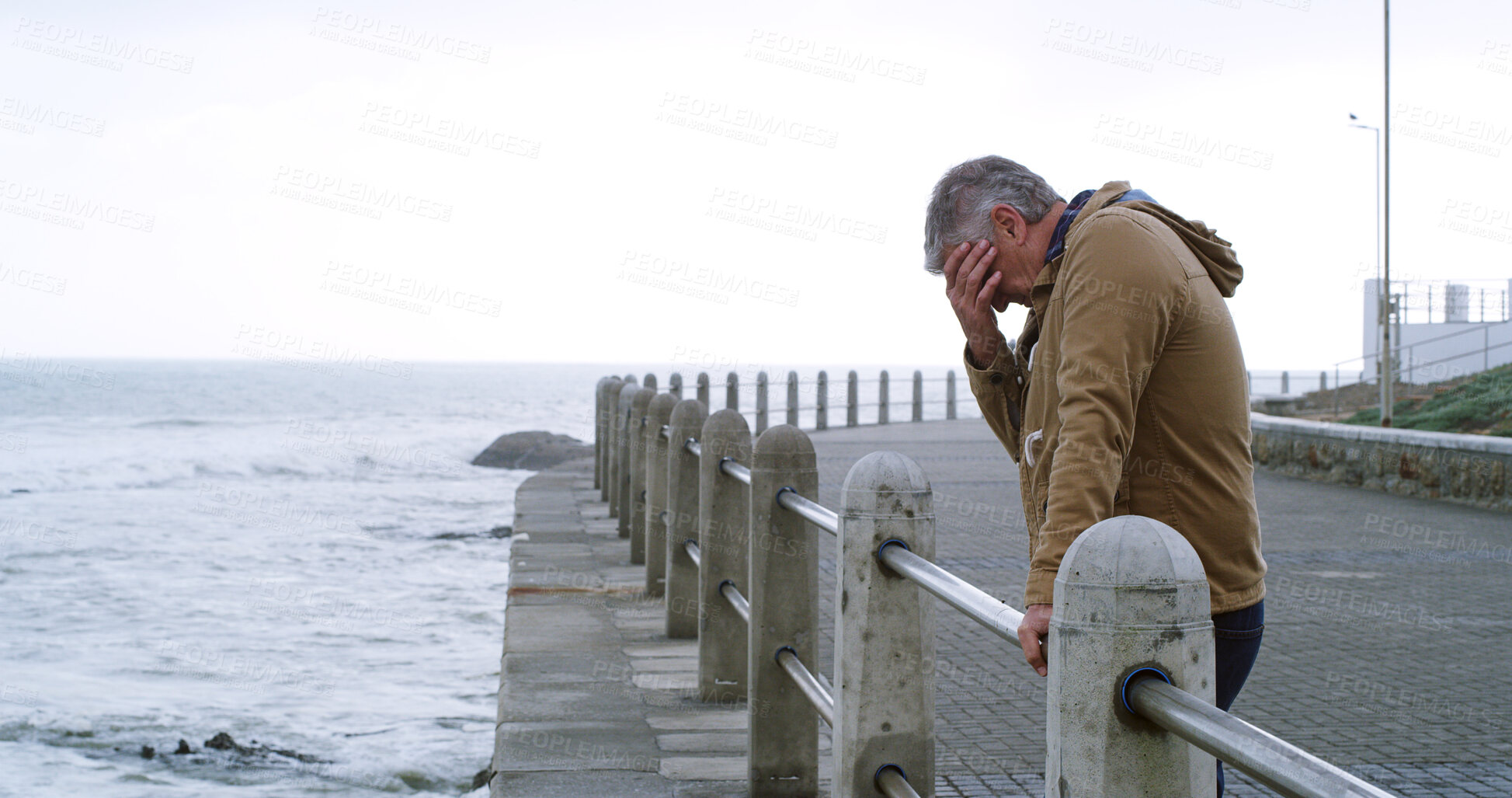 Buy stock photo Senior man, thinking and sad by sea promenade with headache, stress and reflection. Person, depression and insight for mistake, crying and decision with anxiety by ocean, waves and outdoor in Italy