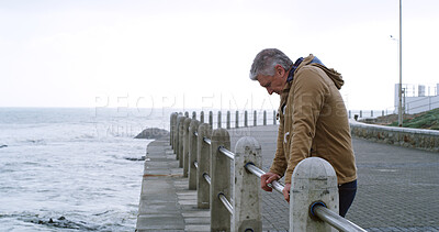 Buy stock photo Mature man, thinking and stress by ocean with outdoor, planning or reflection for break on weekend. Male person, mental health and wellness by seaside, beach or water for ideas, memory or mindfulness