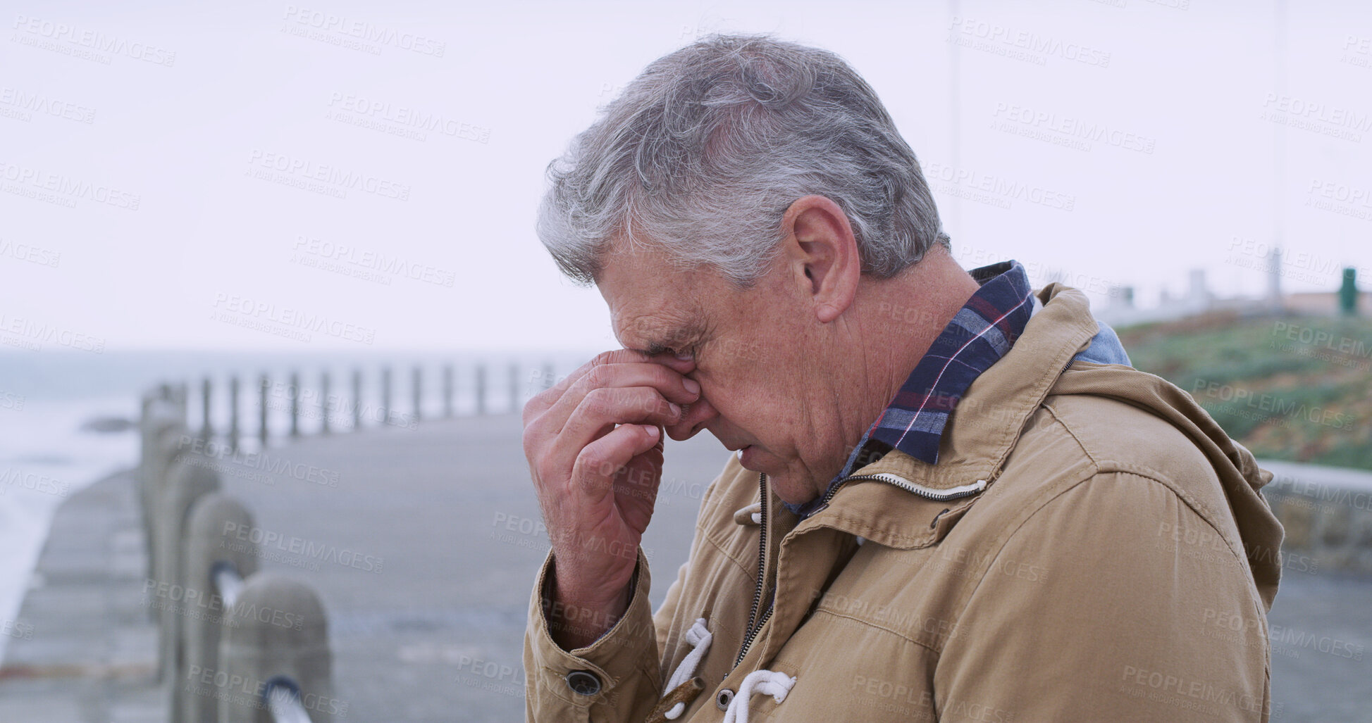 Buy stock photo Senior man, thinking and depression by sea promenade with headache, stress and reflection. Person, sad and insight for mistake, crying and decision with anxiety by ocean, waves and outdoor in Italy