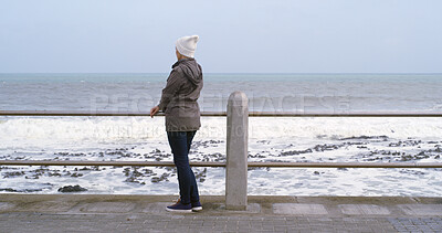 Buy stock photo Back, woman and thinking with outdoor by ocean for relax, planning and reflection on weekend. Female person, mental health and wellness by seaside or water for ideas, memory and mindfulness for break