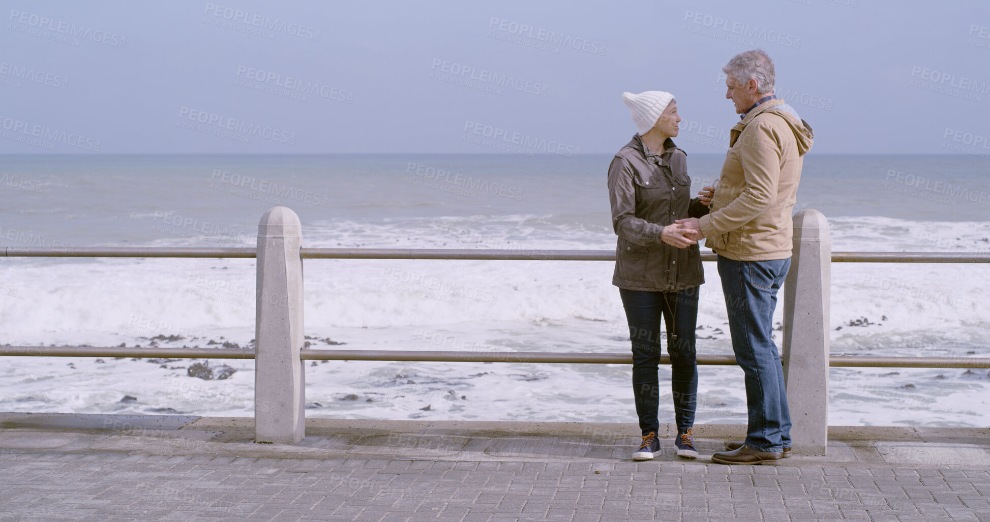 Buy stock photo Mature couple, holding hands and support by ocean, water and beach for love, partner and bonding. Woman, man and affection in relationship, marriage and care with outdoor or space on holiday together