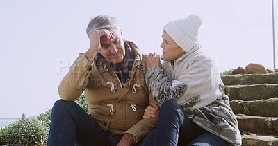 Buy stock photo Comfort, sad and hug with senior couple in outdoor for support, depression and bad news. Communication, anxiety and mental health with elderly man and woman for retirement, bonding and empathy