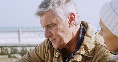 Buy stock photo Comfort, sad and care with senior couple at beach for support, depression and bad news. Communication, anxiety and mental health with elderly man and woman for retirement, bonding and empathy