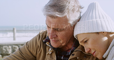 Buy stock photo Comfort, depression and hug with senior couple at beach for support, sad and bad news. Communication, anxiety and mental health with elderly man and woman for retirement, bonding and empathy