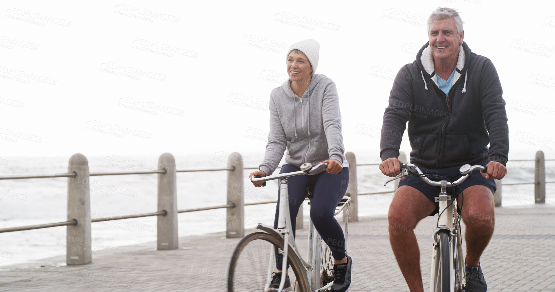 Buy stock photo Senior couple, happy and bike on promenade with exercise, adventure and outdoor on winter morning. People, man and woman with cycling, bicycle and smile with bonding, workout and fitness in England