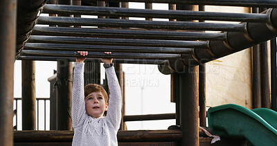 Buy stock photo Boy, child and swing on monkey bars at playground, outdoor or adventure with lifting, learning and balance. Kid, memory and exercise on jungle gym at park for challenge, climbing or sunshine in Spain