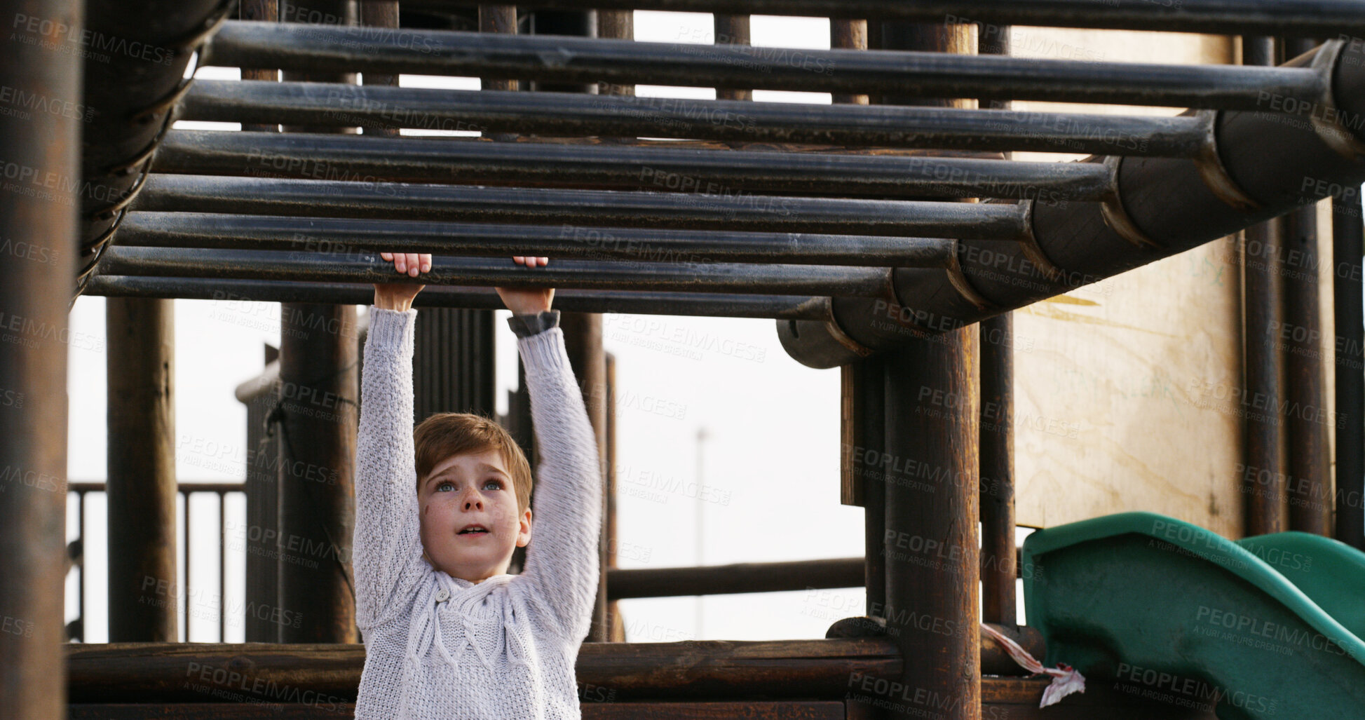 Buy stock photo Boy, child and swing on monkey bars at playground, outdoor or adventure with lifting, learning and balance. Kid, memory and exercise on jungle gym at park for challenge, climbing or sunshine in Spain