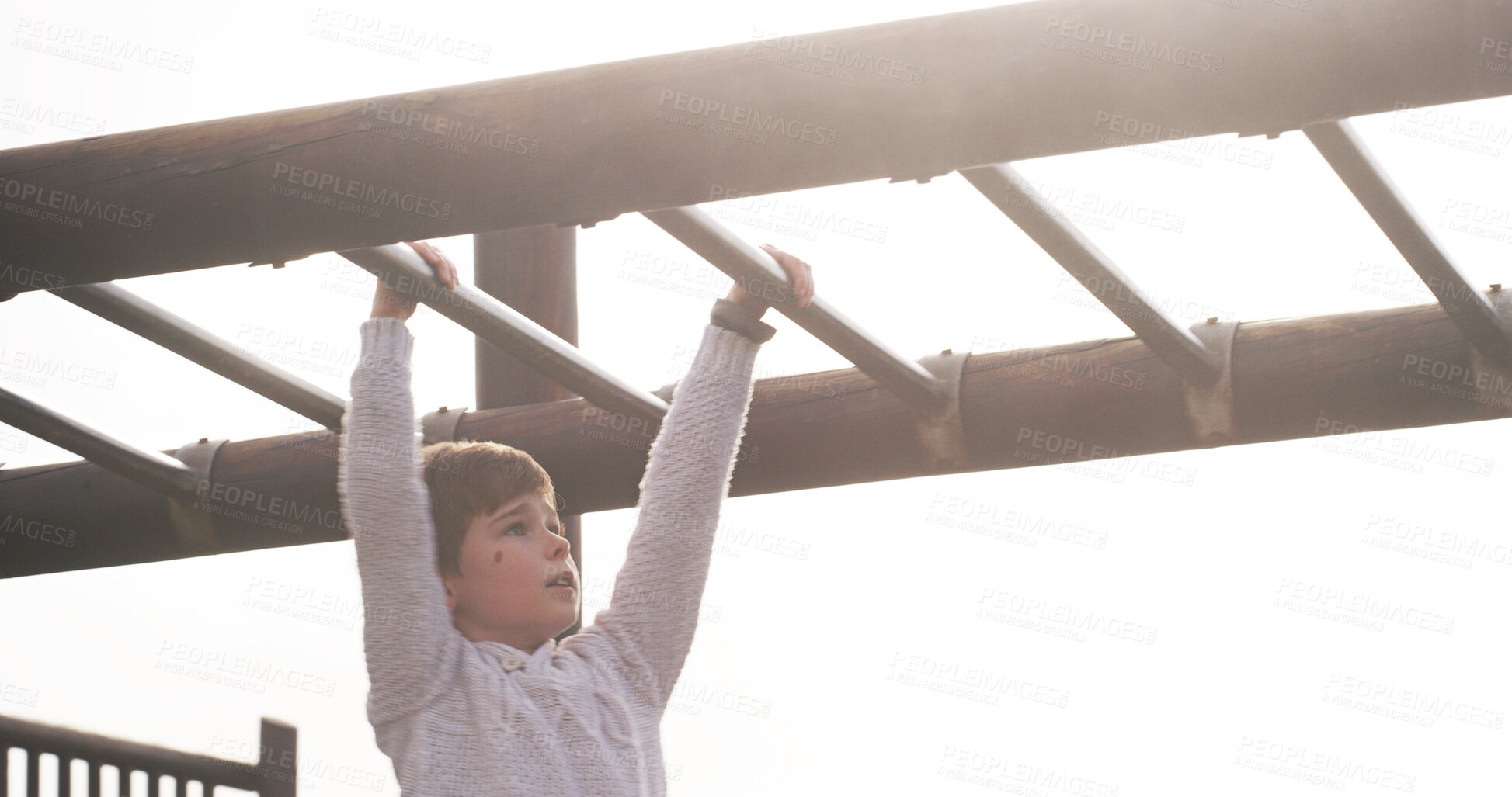 Buy stock photo Boy, child and park on monkey bars at playground, swing or adventure for lifting, learning or balance. Kid, memory and exercise on jungle gym for challenge, climbing or outdoor with sunshine in Spain