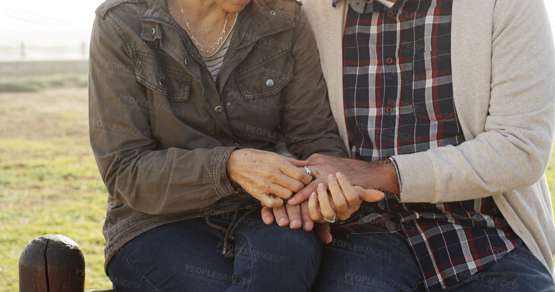 Buy stock photo Love, wedding ring and couple holding hands outdoor for commitment, romance or loyalty. Marriage, man and mature woman in nature together for relationship, engagement and valentines day celebration