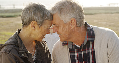 Buy stock photo Outdoor, senior couple and smile with forehead touch care, trust and love. People, ocean and happy as pensioners on retirement in relationship for break, relax and appreciation on valentines day