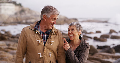 Buy stock photo Laugh, love and mature couple by ocean for bonding, relationship or talking in nature. Walking, marriage and man and woman by sea in conversation for romance, commitment and relax together on weekend