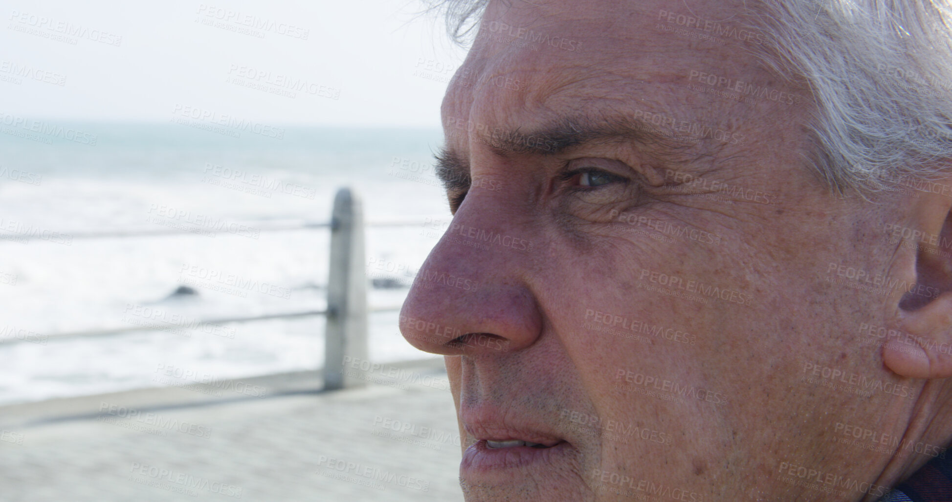 Buy stock photo Sad, beach and mature man with thinking, grief and loss with depression and stress on promenade. Lonely, sea and winter vacation with closeup, memory and bad news by ocean to remember the past