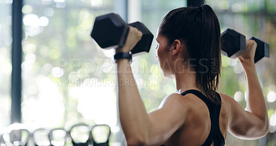 Buy stock photo Back, dumbbells and fitness with woman in gym for physical improvement or strength training. Power, shoulders and workout with person lifting weights in health club for arm, bicep or muscle exercise