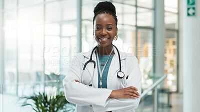 Buy stock photo Black woman, doctor and happy with arms crossed at hospital for medical service in Uganda. Female person, portrait and smile or proud in confidence for career growth, healthcare and treatment