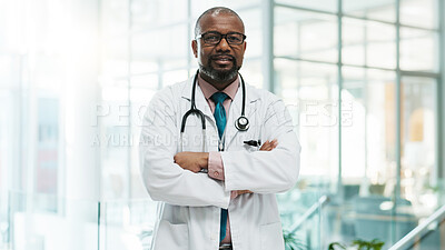 Buy stock photo Black man, doctor and smile with arms crossed at hospital for medical service in Uganda. Mature person, portrait and proud as employee in confidence for career growth, healthcare and treatment