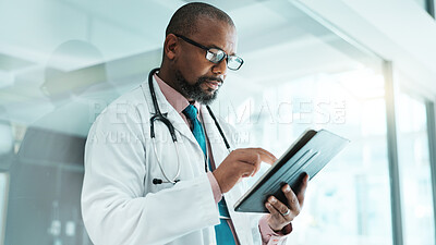 Buy stock photo Black man, doctor and tablet for healthcare in hospital with medical research, Telehealth and surgery schedule. Male surgeon, reading and digital for history report, patient information and diagnosis