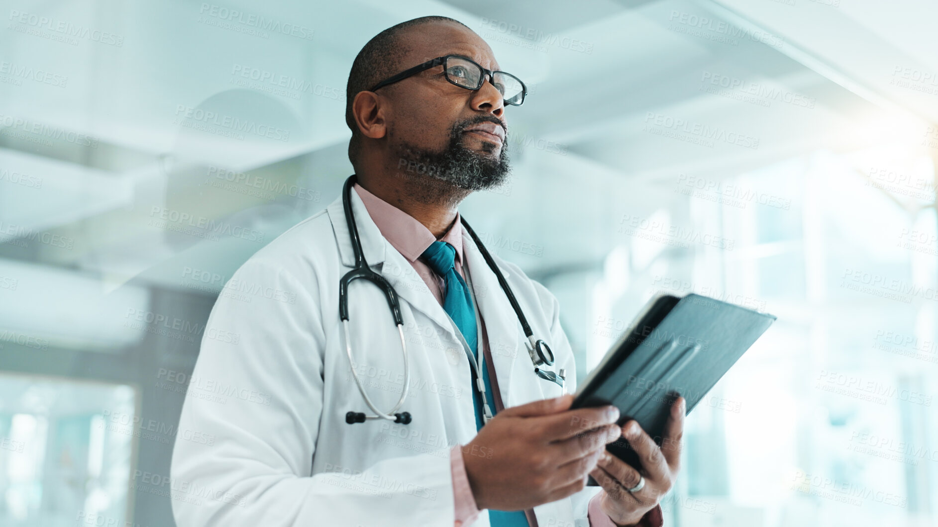 Buy stock photo Thinking, black man and doctor with tablet at clinic for medical research, Telehealth and surgery schedule. Male surgeon, planning and digital with history report, patient information and diagnosis