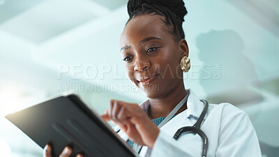 Buy stock photo Black woman, doctor and satisfied with tablet at hospital for medical records, report and data. Female person, employee and smile or happy at clinic on website for telehealth, healthcare and schedule